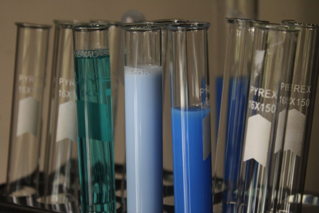 Laboratory test tubes holding different coloured liquid formulations in a rack, representing the product testing and quality-control process behind Malaysia's OEM pet grooming and pet shampoo manufacturers featured in this 2026 Malaysia OEM guide.